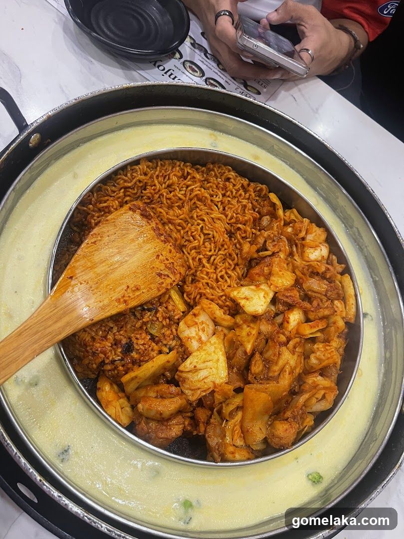 Food dish in a metal bowl with wooden spoon