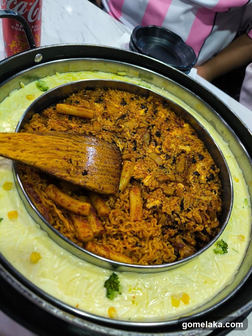 Food dish in a metal bowl with wooden spoon