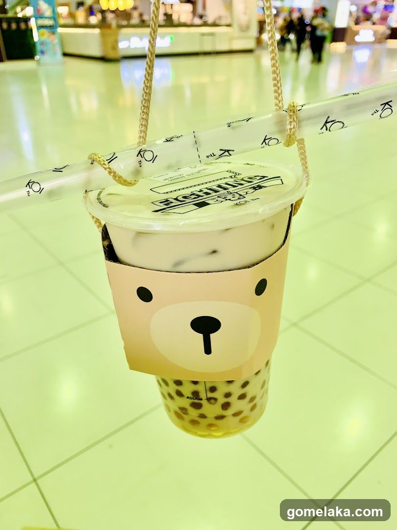Boba tea cup with bear design hanging in mall