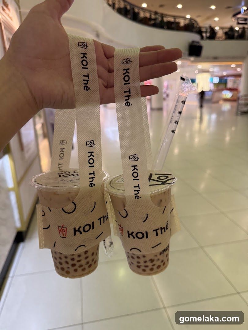 Two bubble tea drinks with branded straps