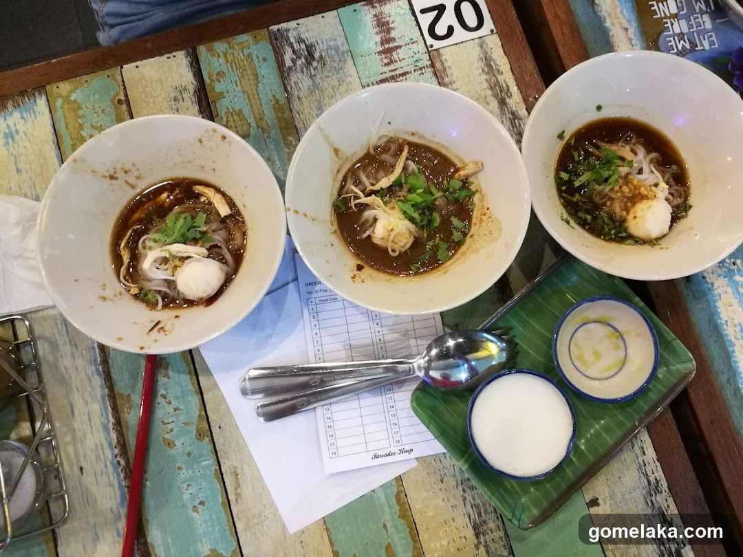 Table with bowls of soup and condiments