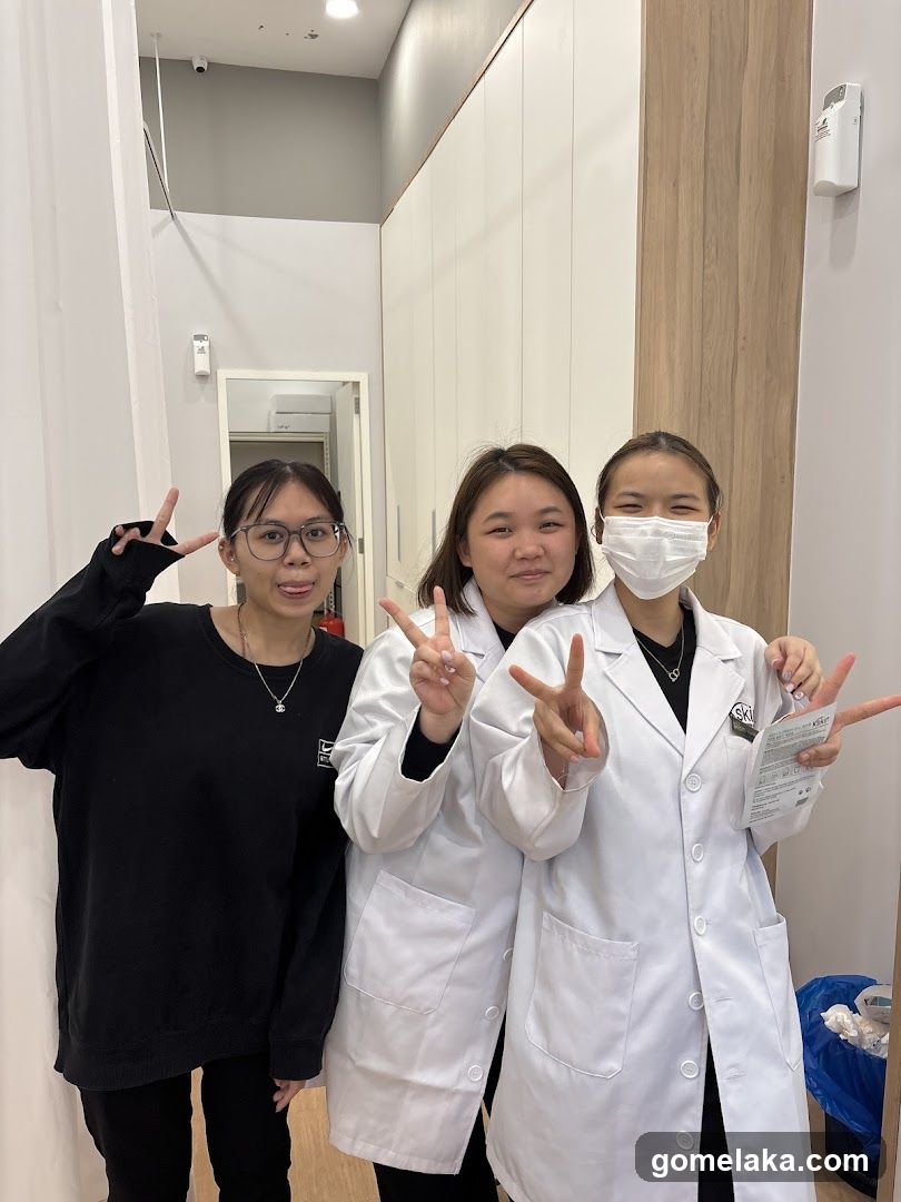 Three individuals posing in a medical or clinical setting