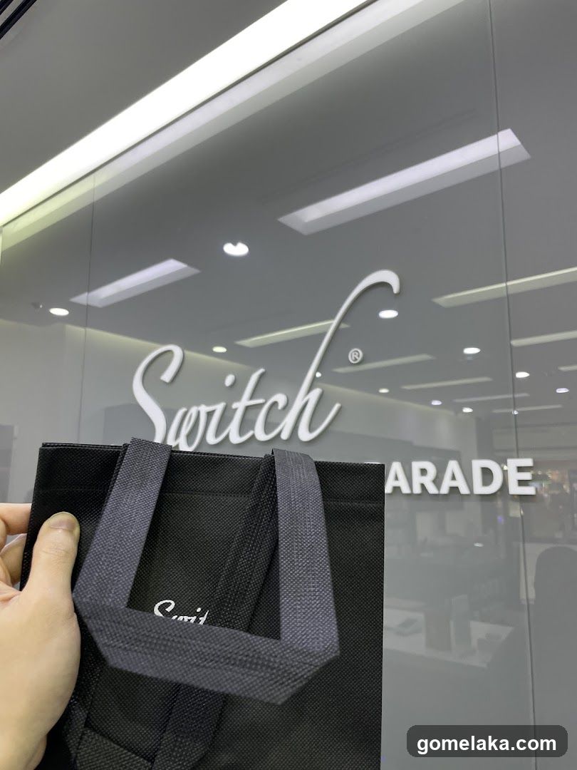 Hand holding shopping bag in front of storefront