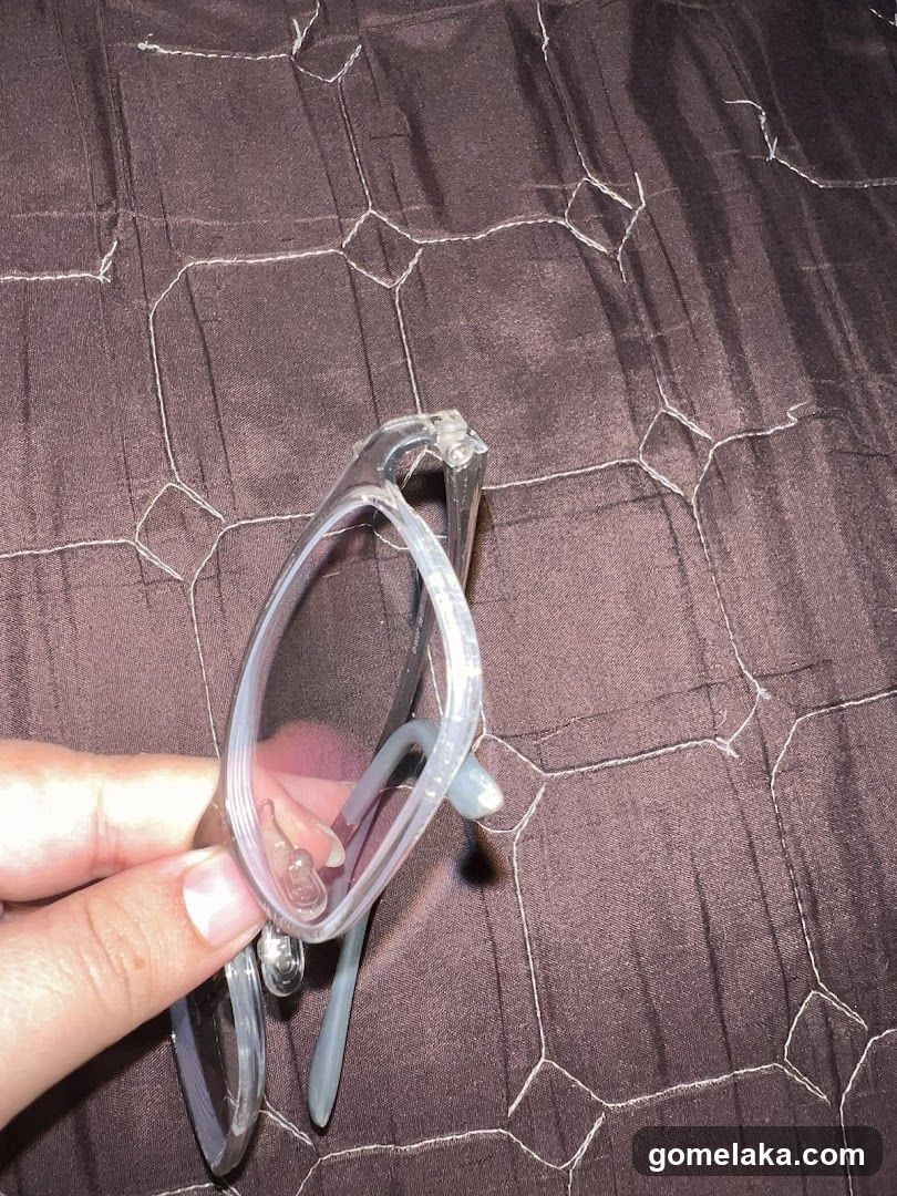 Hand Holding Glasses on Fabric