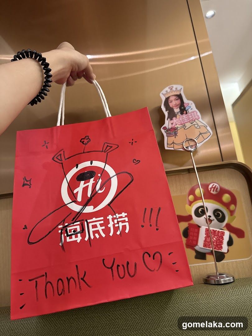 Red shopping bag with handwritten message and logo
