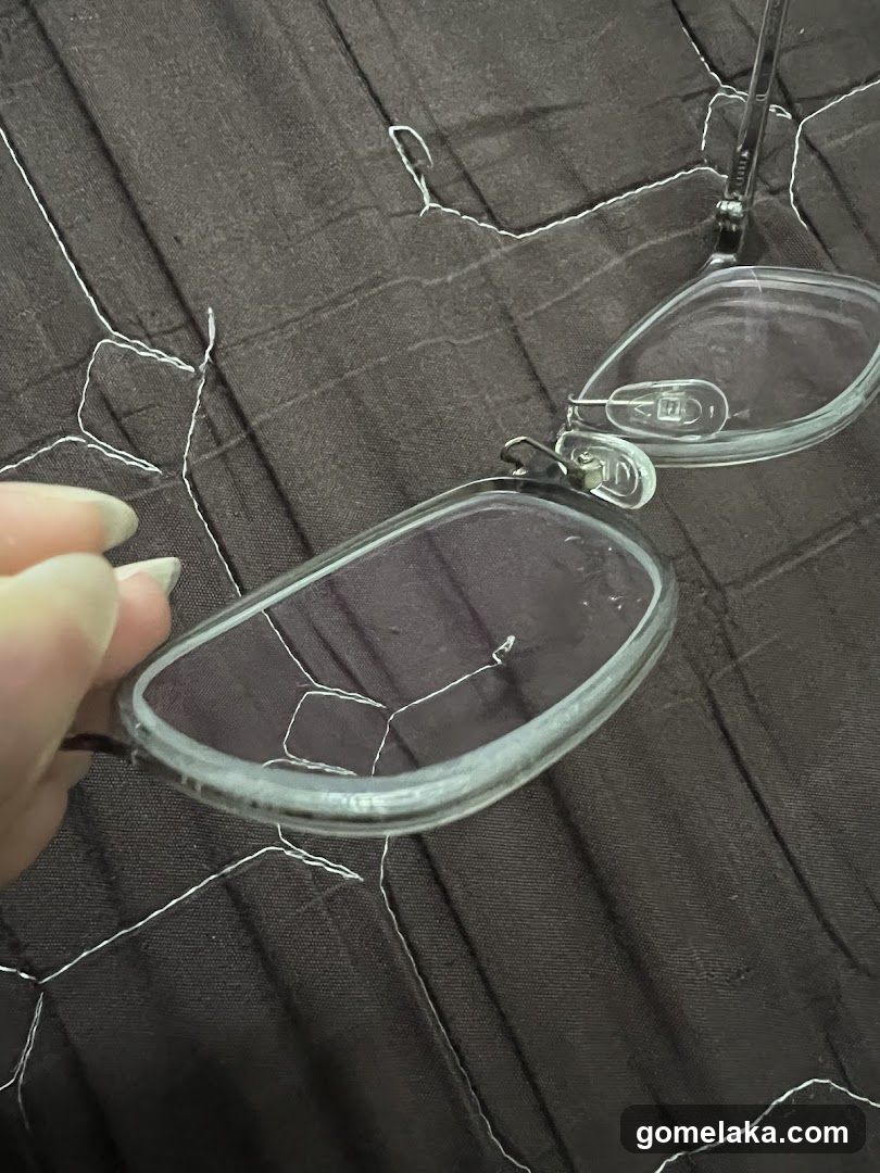 Hand Holding Glasses on Fabric