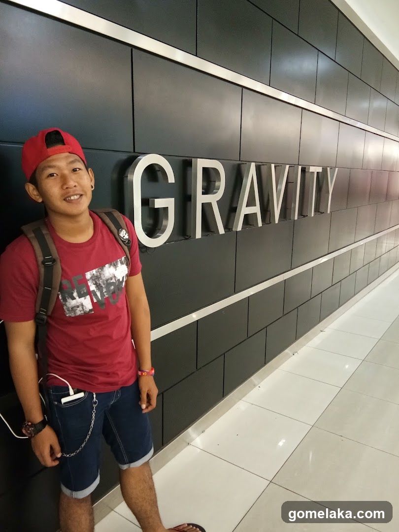 Person standing beside wall signage