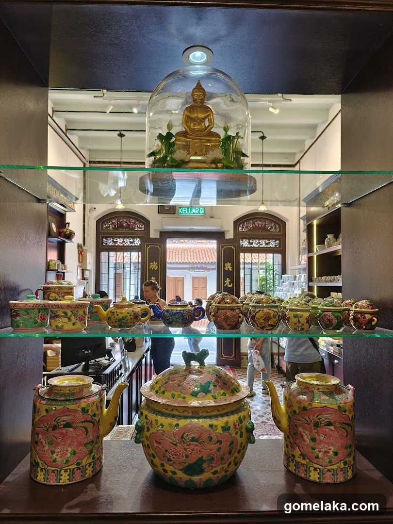 Interior Display of Traditional Teapots and Buddha Statue
