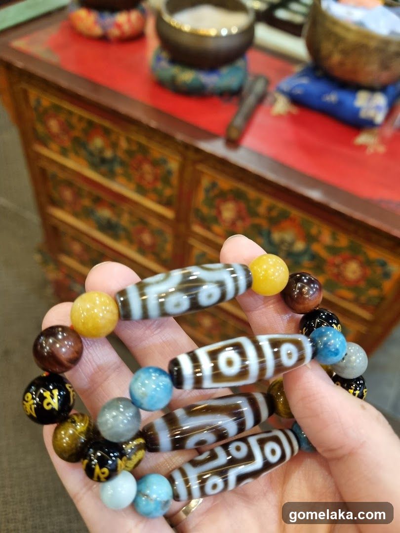 Hand holding Tibetan Buddhist beads