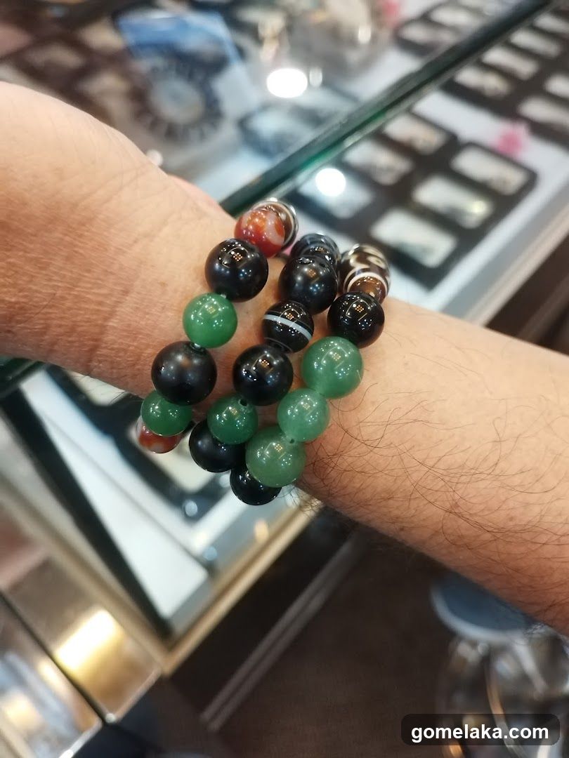 Hand wearing beaded bracelets