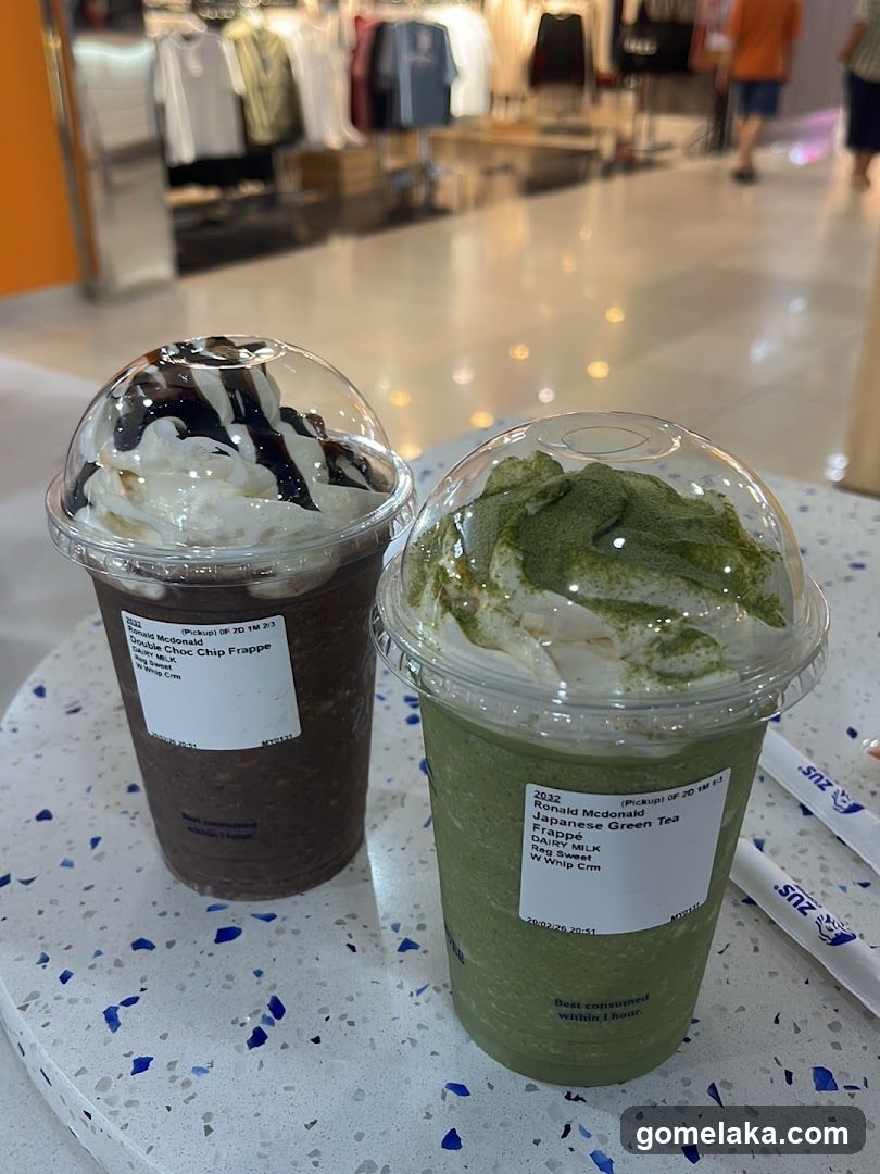 Two beverages on a table in a shopping mall