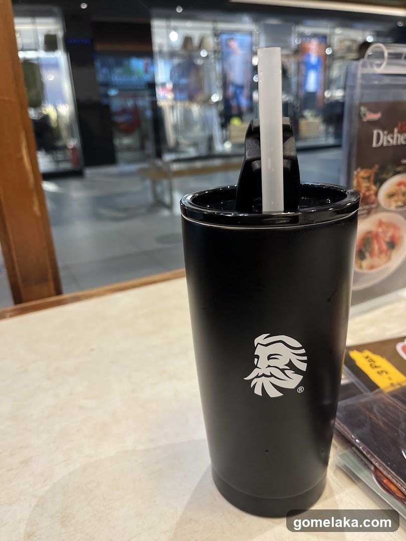 Black Tumbler with Straw on Counter
