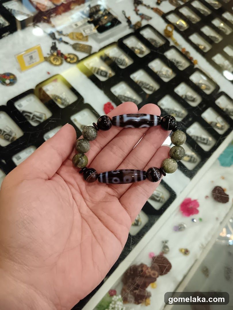 Hand holding beaded bracelet in jewelry shop