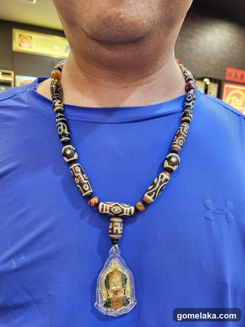 Person wearing a beaded necklace with pendant