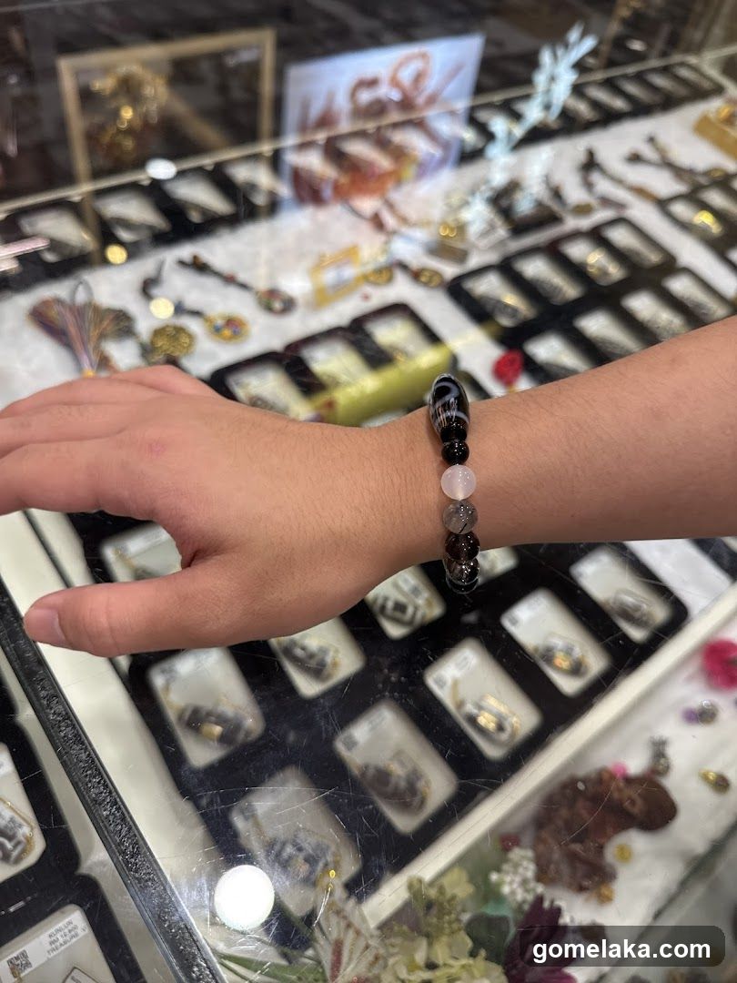 Hand wearing bracelet in jewelry display