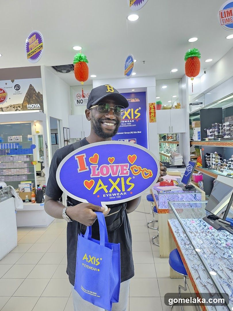 Customer Holding Axis Eyewear Sign and Bag Inside Store
