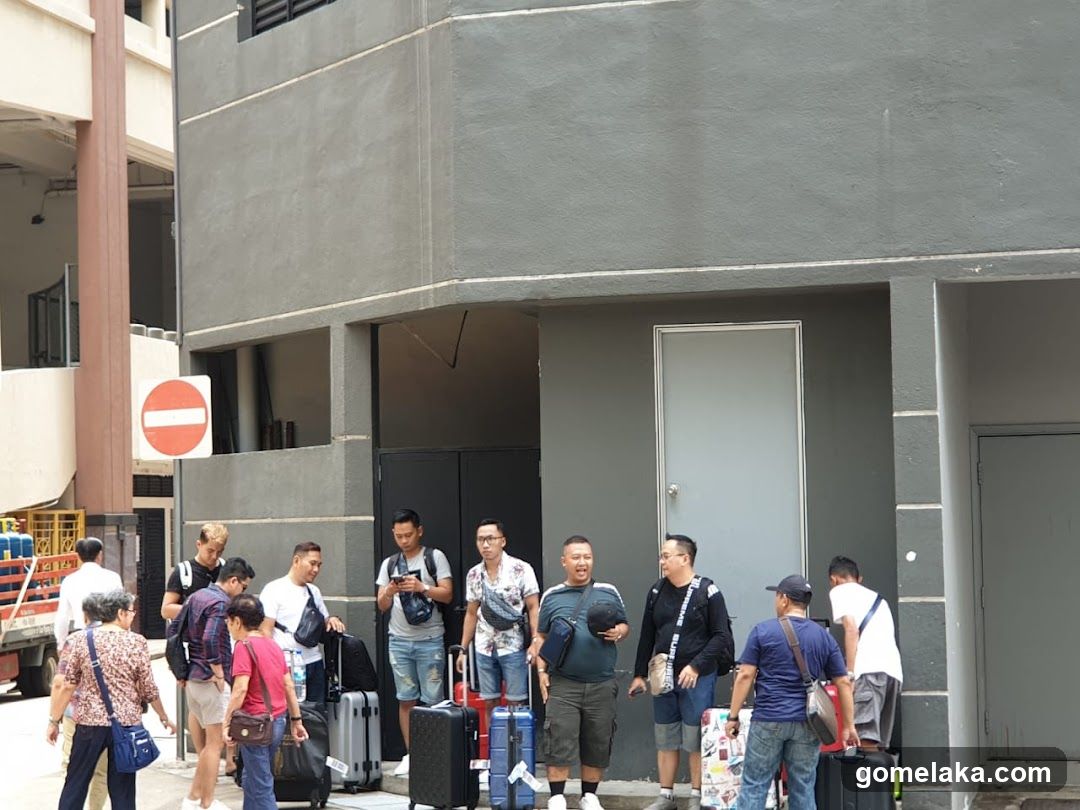 Group of travelers with luggage outside building