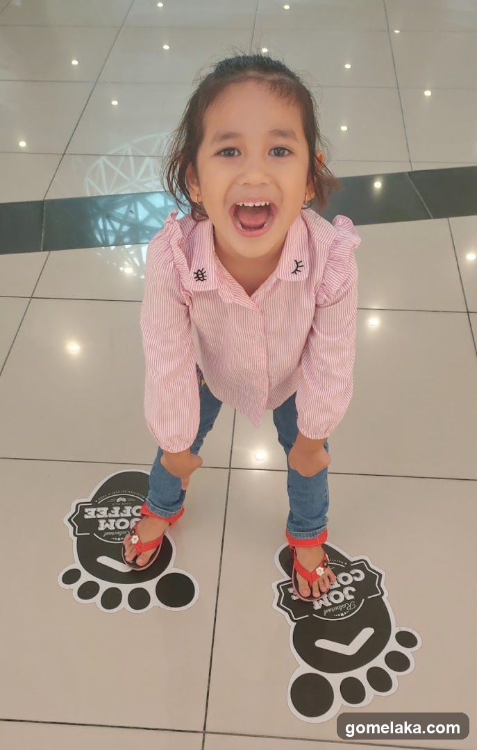 Child in shopping mall interior