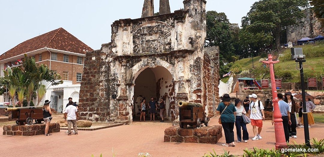 Historic Archway with Tourists and Cannons