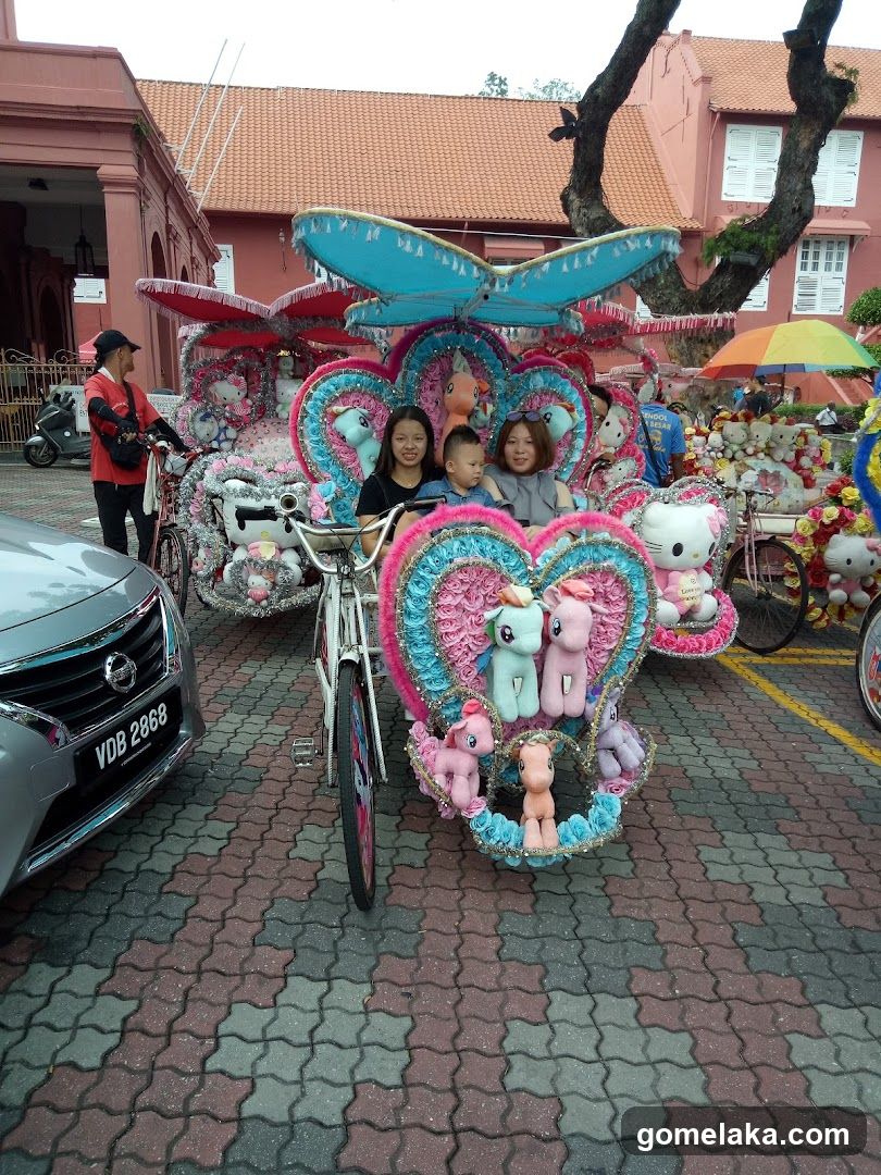 Decorated tricycle with passengers and plush toys