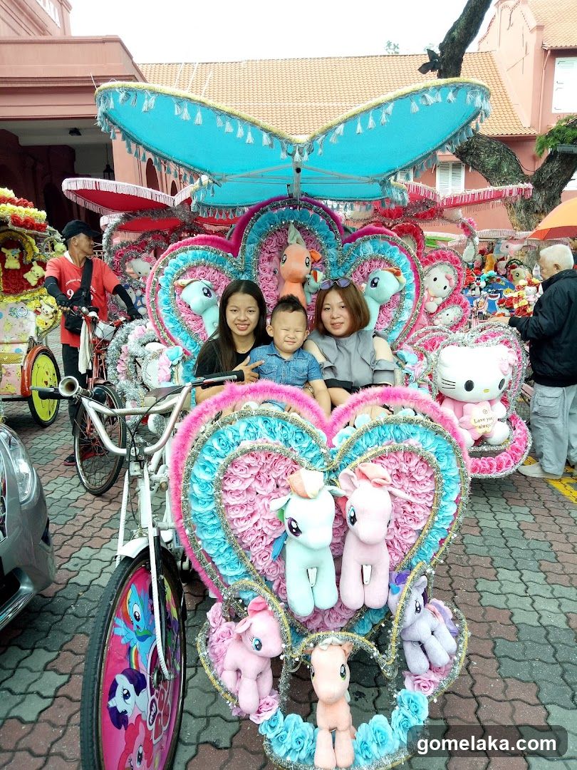 Family posing in decorative tricycle