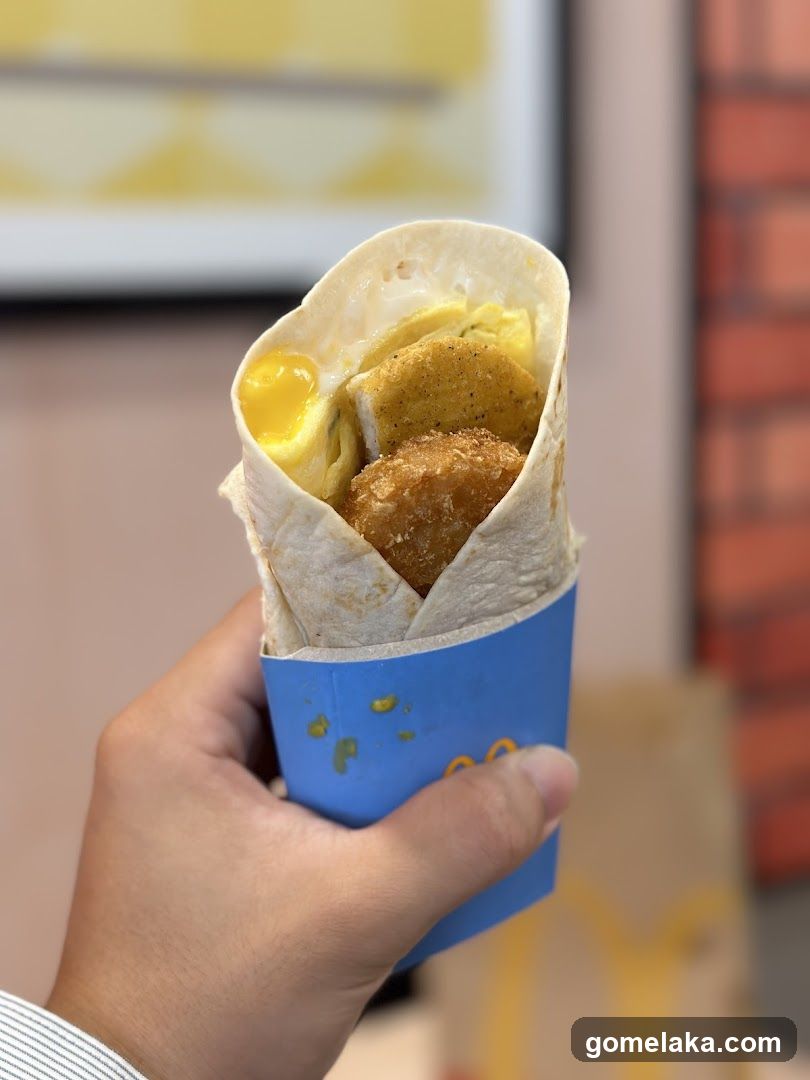 Hand holding wrapped food item