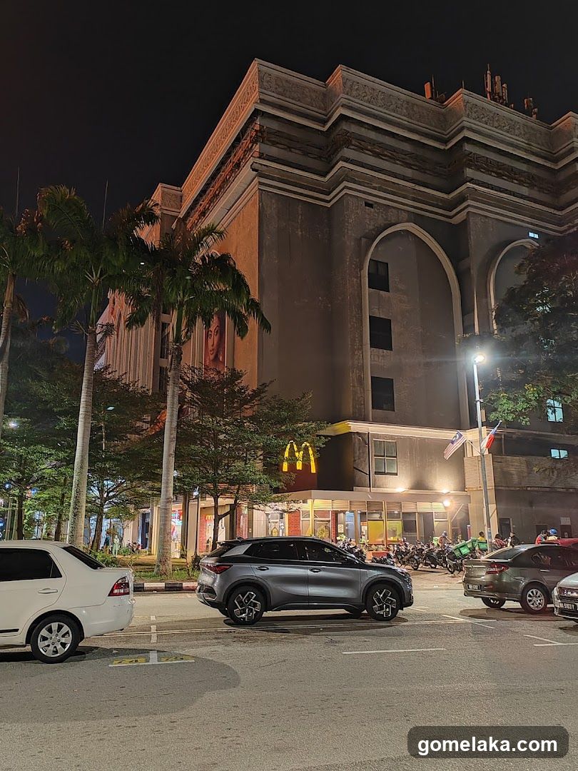 Nighttime Street Scene with Building and Cars