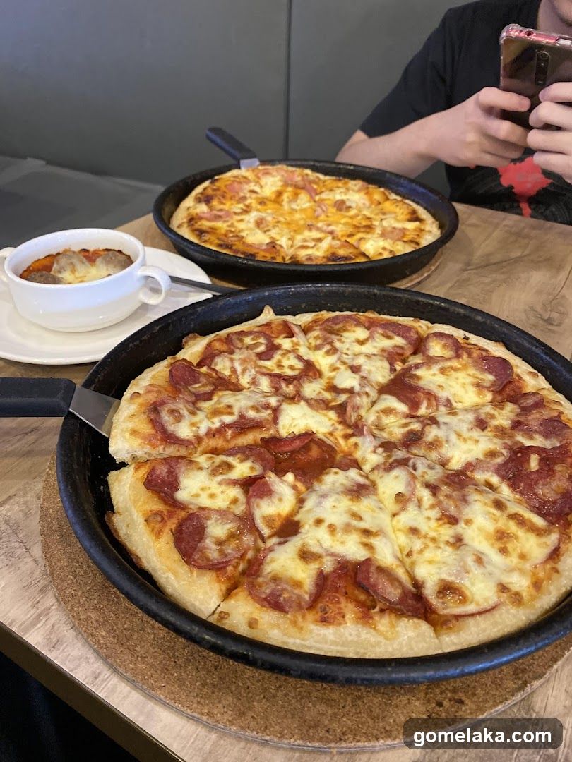 Pizza and beverage at dining table