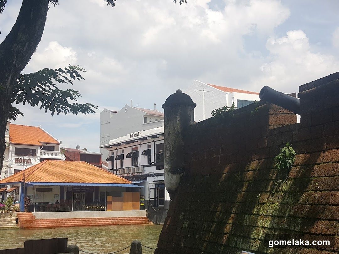 Riverfront Scene with Historic Wall and Buildings