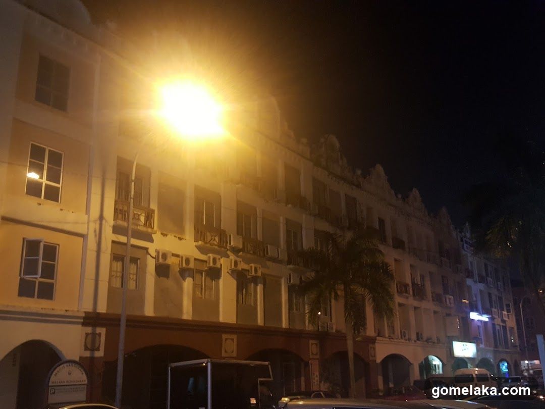 Nighttime street scene with illuminated building facade
