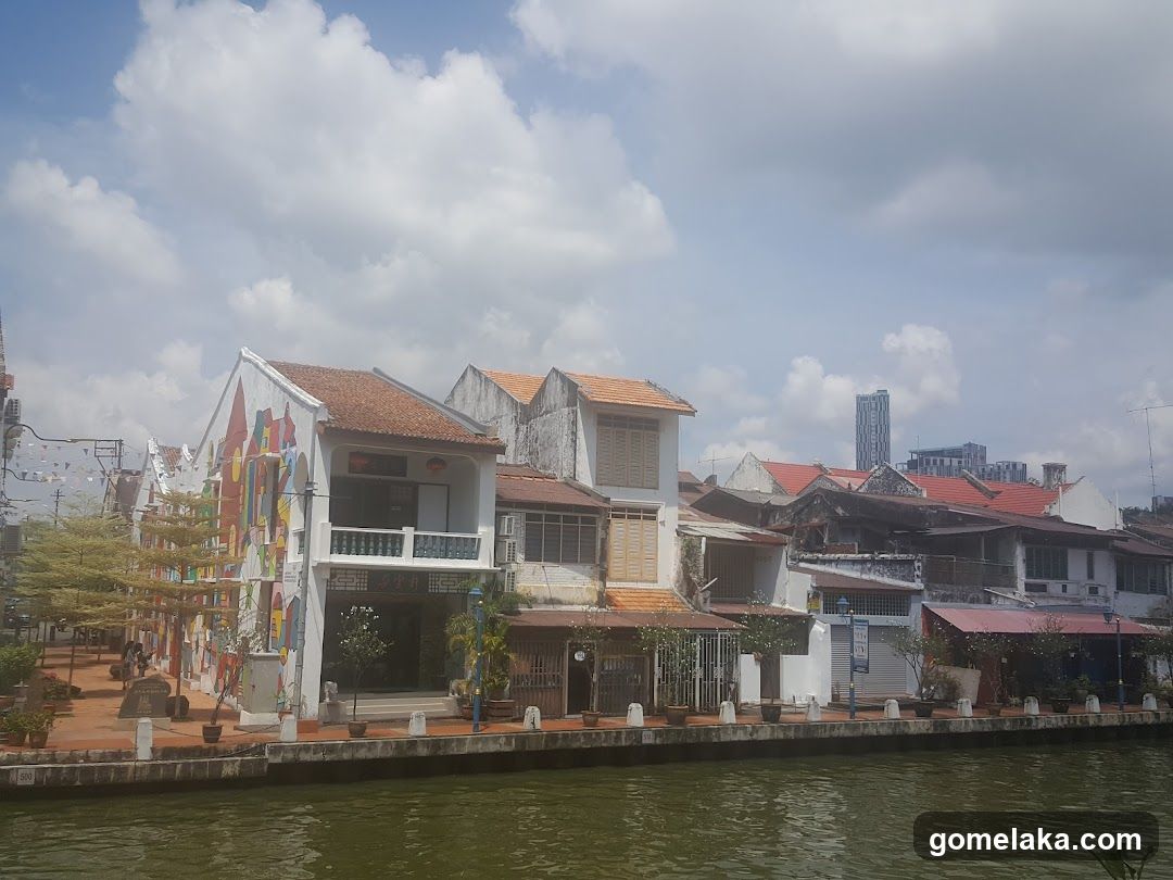 Riverfront buildings with murals and traditional architecture
