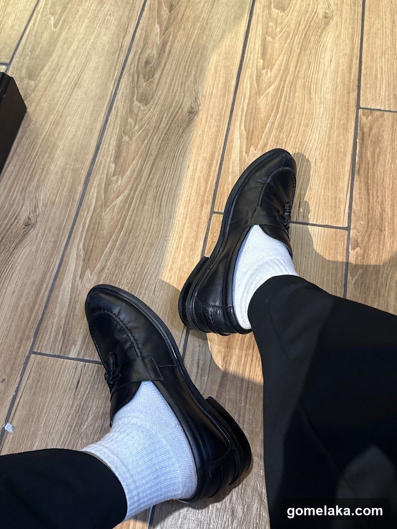 Person's Feet in Formal Shoes and Socks