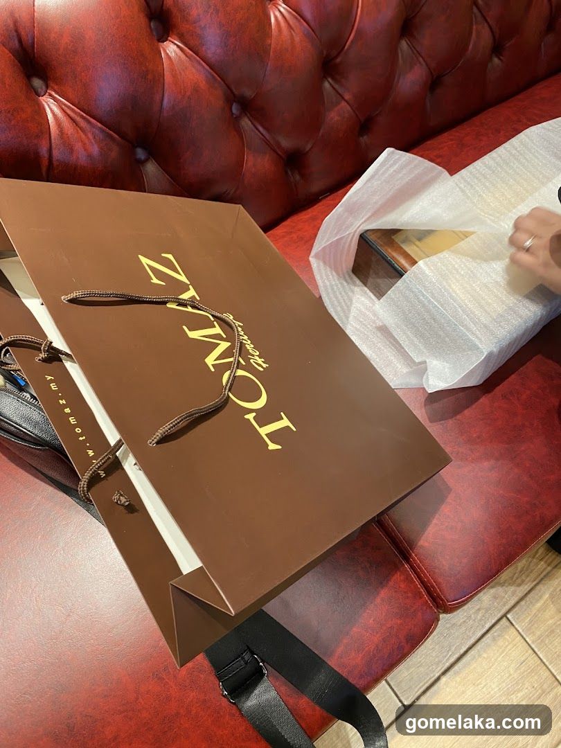Shopping Bag and Packaging on Red Leather Sofa