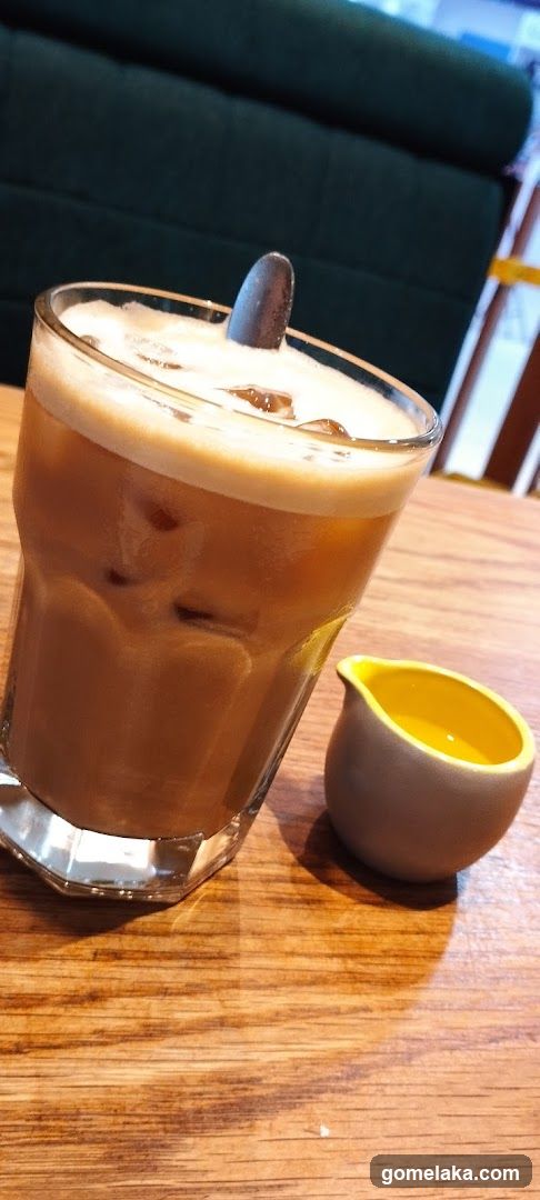 Iced Coffee and Small Pitcher on Wooden Table