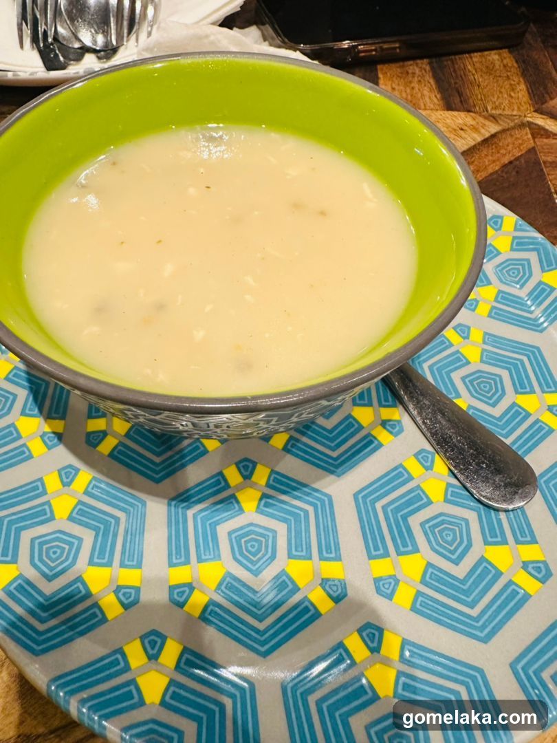 Bowl of soup on patterned plate