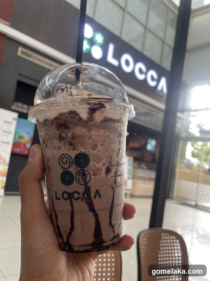 Hand holding a Locca drink