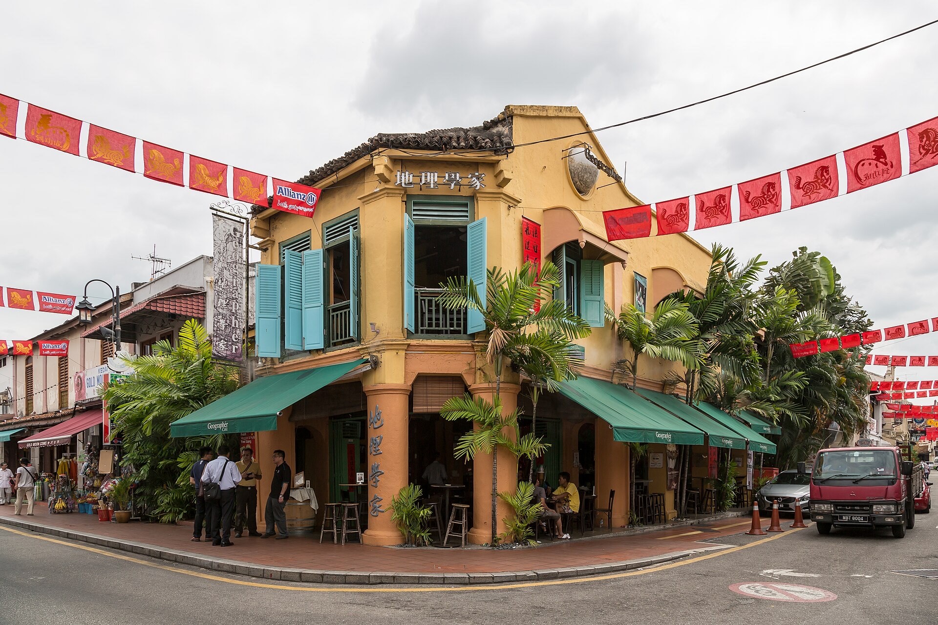 Daytime shophouses on Jalan Hang Jebat, Melaka, with 2026 festive flags