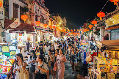 Crowd walking Jonker Street night market Malacca